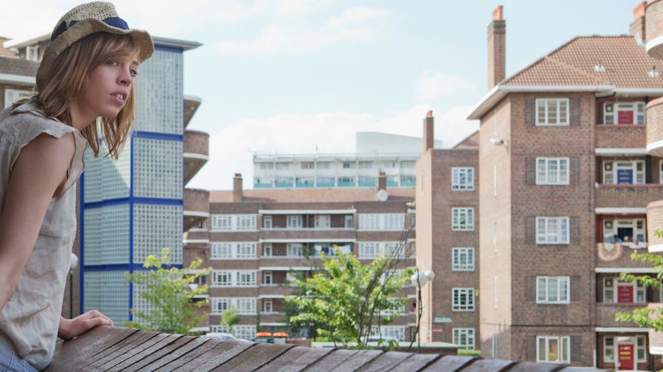 Woman on rooftop looking at surroundings