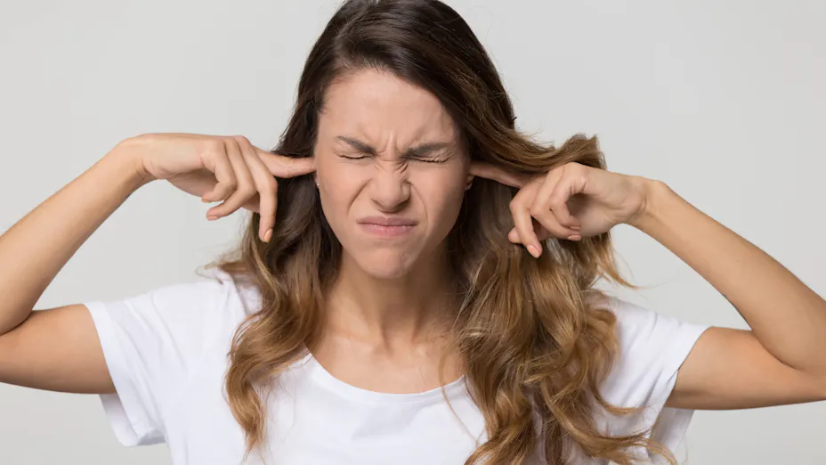 woman covering ears to protect from noise