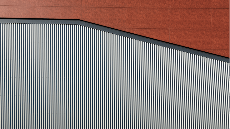 Sports hall 'Lärkan' in Sala, Sweden cladded with Rockpanel Stones Mineral Rust and Basalt Iron facade cladding.