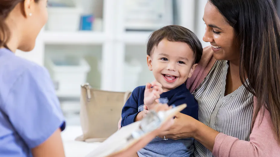 Smiling child and mother at medical office