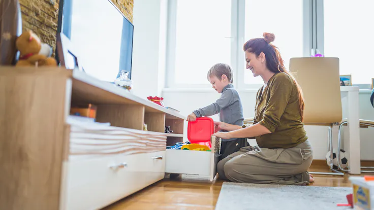 Pregnant mother and her son spending time together, playing at home
