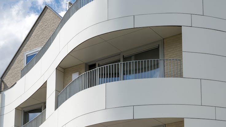 Multi Family housing in Ypres, Belgium cladded with Rockpanel Colours and curved.