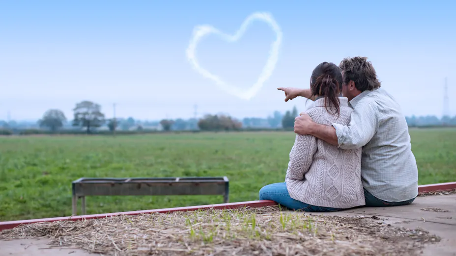 Young couple overlooking a green field
