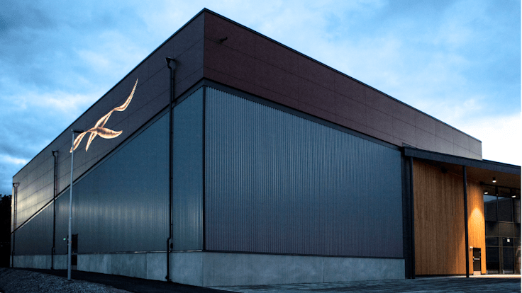 Sports hall 'Lärkan' in Sala, Sweden cladded with Rockpanel Stones Mineral Rust and Basalt Iron facade cladding.