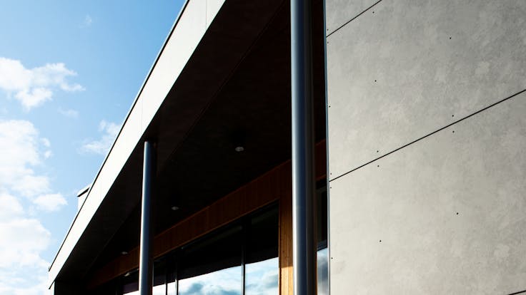 Sports hall 'Lärkan' in Sala, Sweden cladded with Rockpanel Stones Mineral Rust and Basalt Iron facade cladding.