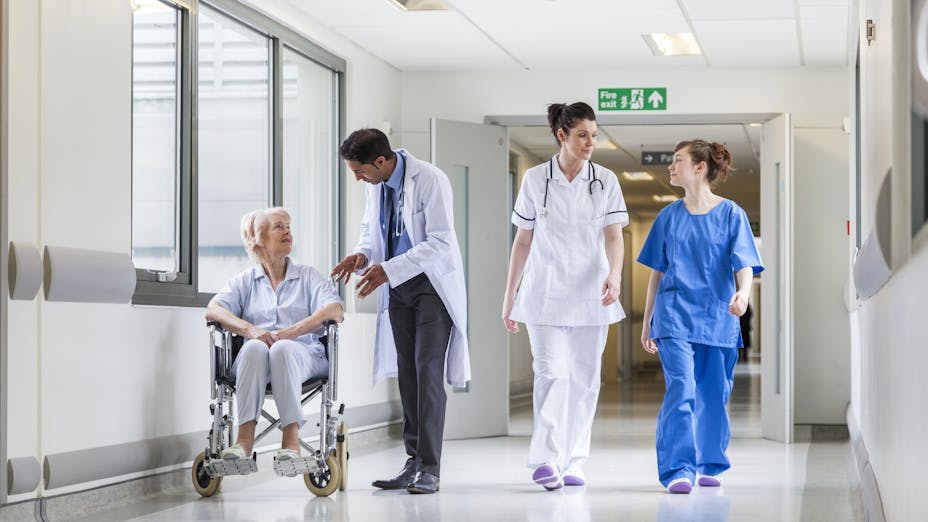 Quiet hospital corridor with patients and staff