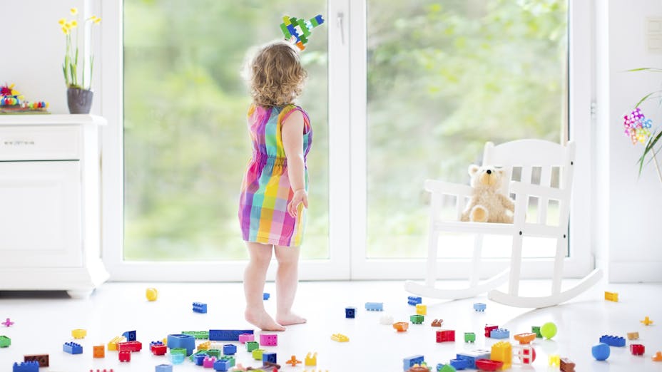 Young girl playing with toy bricks
