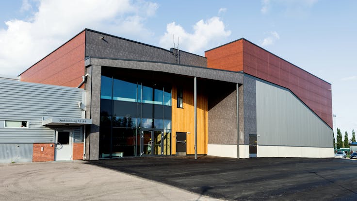 Sports hall 'Lärkan' in Sala, Sweden cladded with Rockpanel Stones Mineral Rust and Basalt Iron facade cladding.