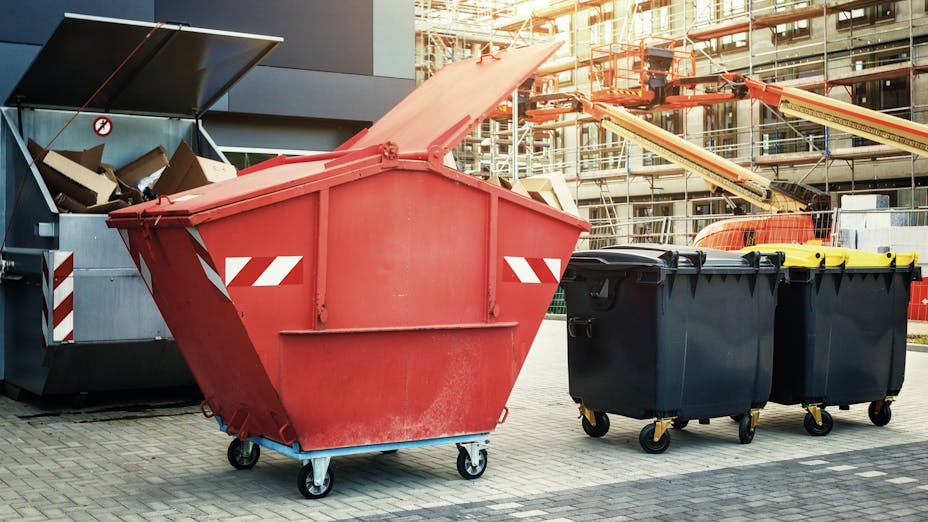 Picture of trash cans next to building site