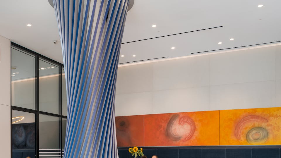 Double height reception with feature column and an integrated seamless acoustic ceiling