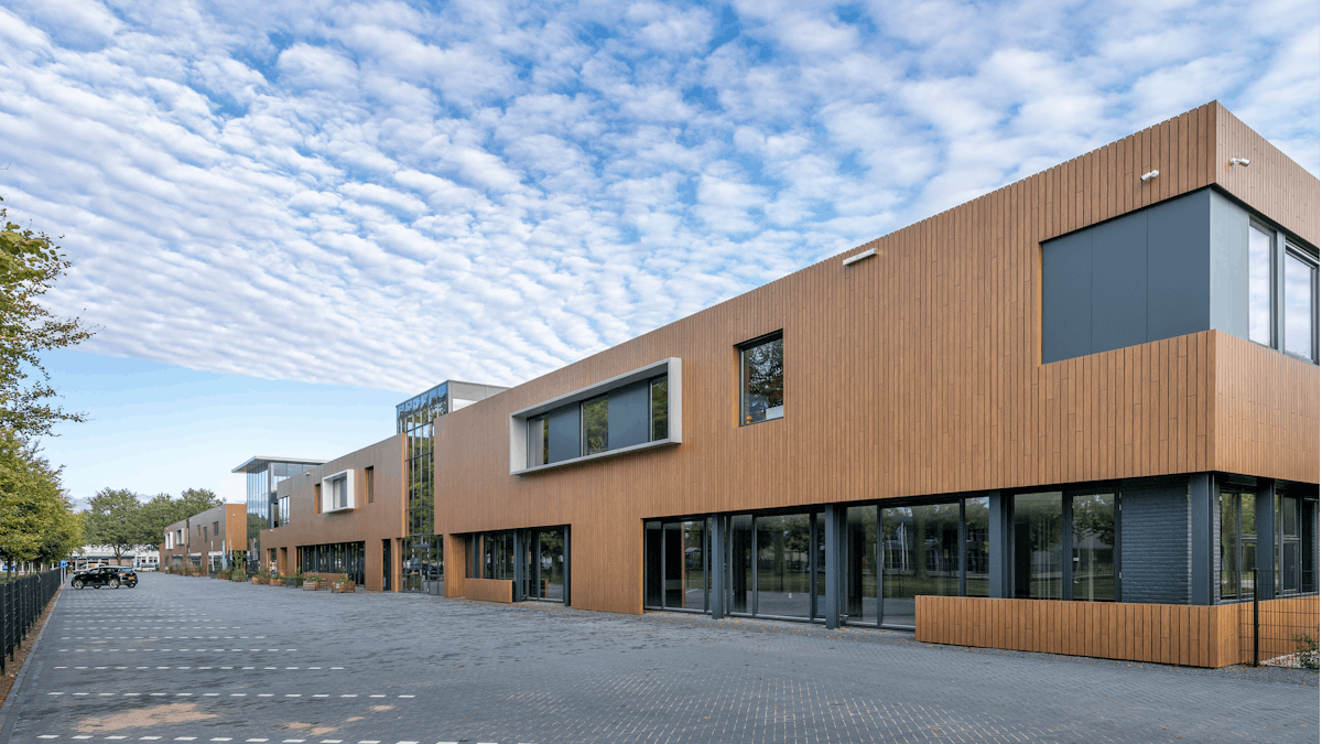 EromesMarko office building and factory in Wijchen, Netherlands cladded with Rockpanel Woods (custom design) facade cladding.