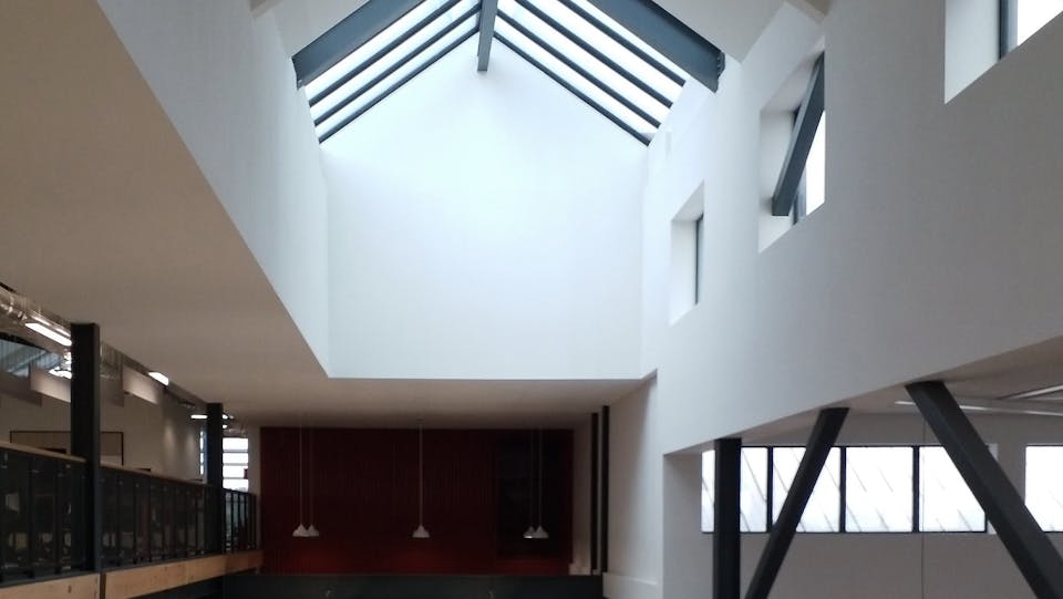 Seamless acoustic ceiling in an office with skylights in roof