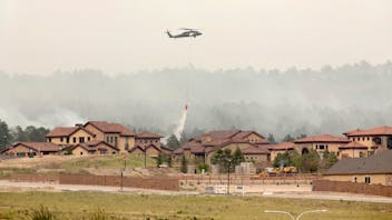 Helicopter water drop on Colorado Springs wildfire stock photo - wildfires and forest fires - wildland urban interface (WUI) zones