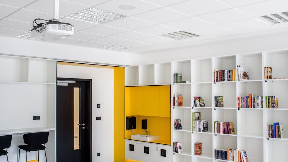 Library in COPaG high school  in Prague Czech Republic with Rockfon Sonar E24-Edge and Rockfon Sonar Bas E24-Edge