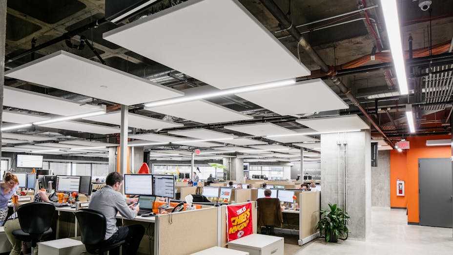Rockfon Alaska acoustic ceiling tiles and panels installed with Rockfon Island within Chicago Metallic 1200 suspension system in open office.