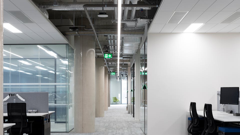 Acoustic ceiling prevents noise transfer from a meeting room in an open plan office