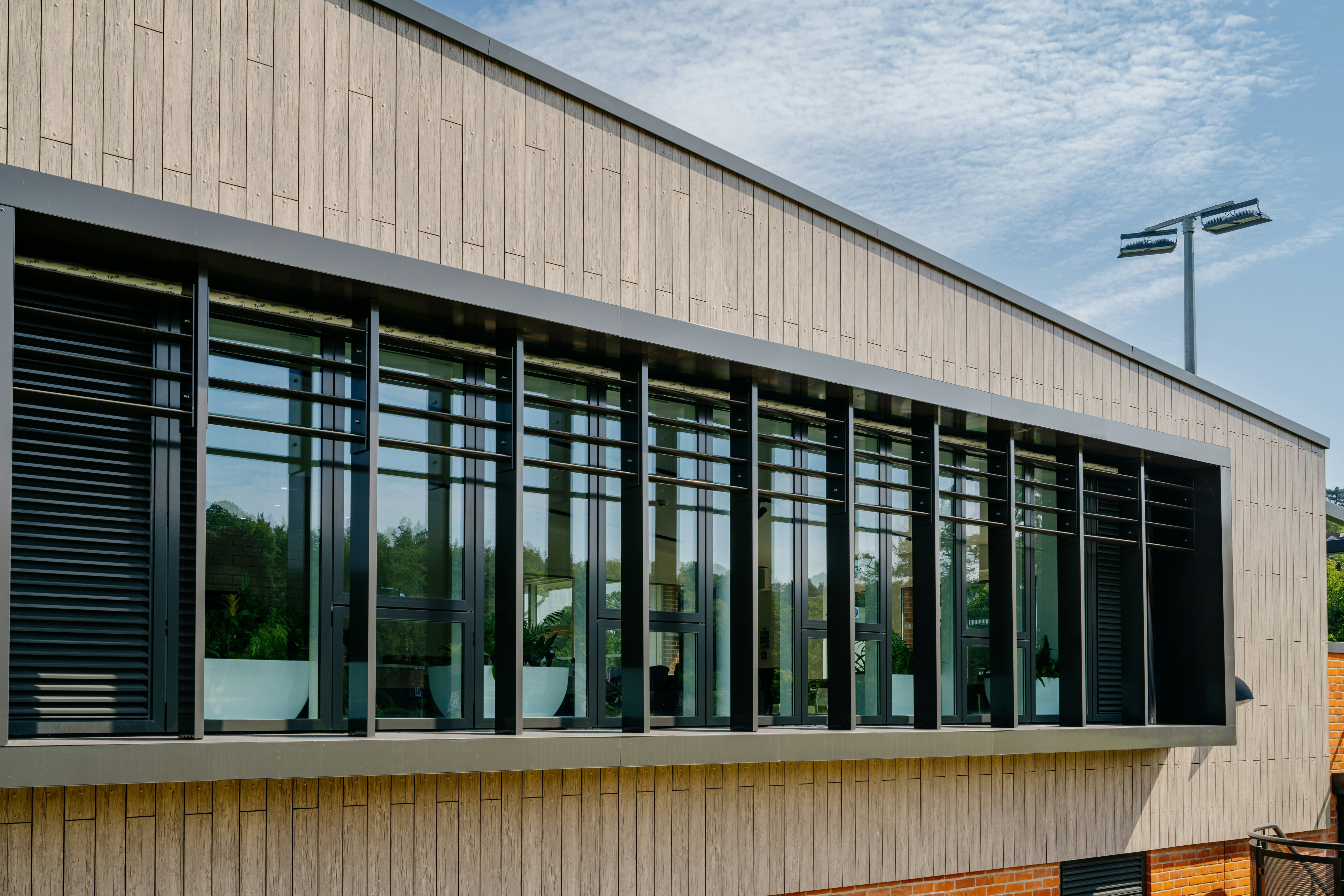 Case Study, Caterham Sports Center, UK, Rockpanel Woods (Rhinestone Oak), Rockpanel Colours (RAL 7030).