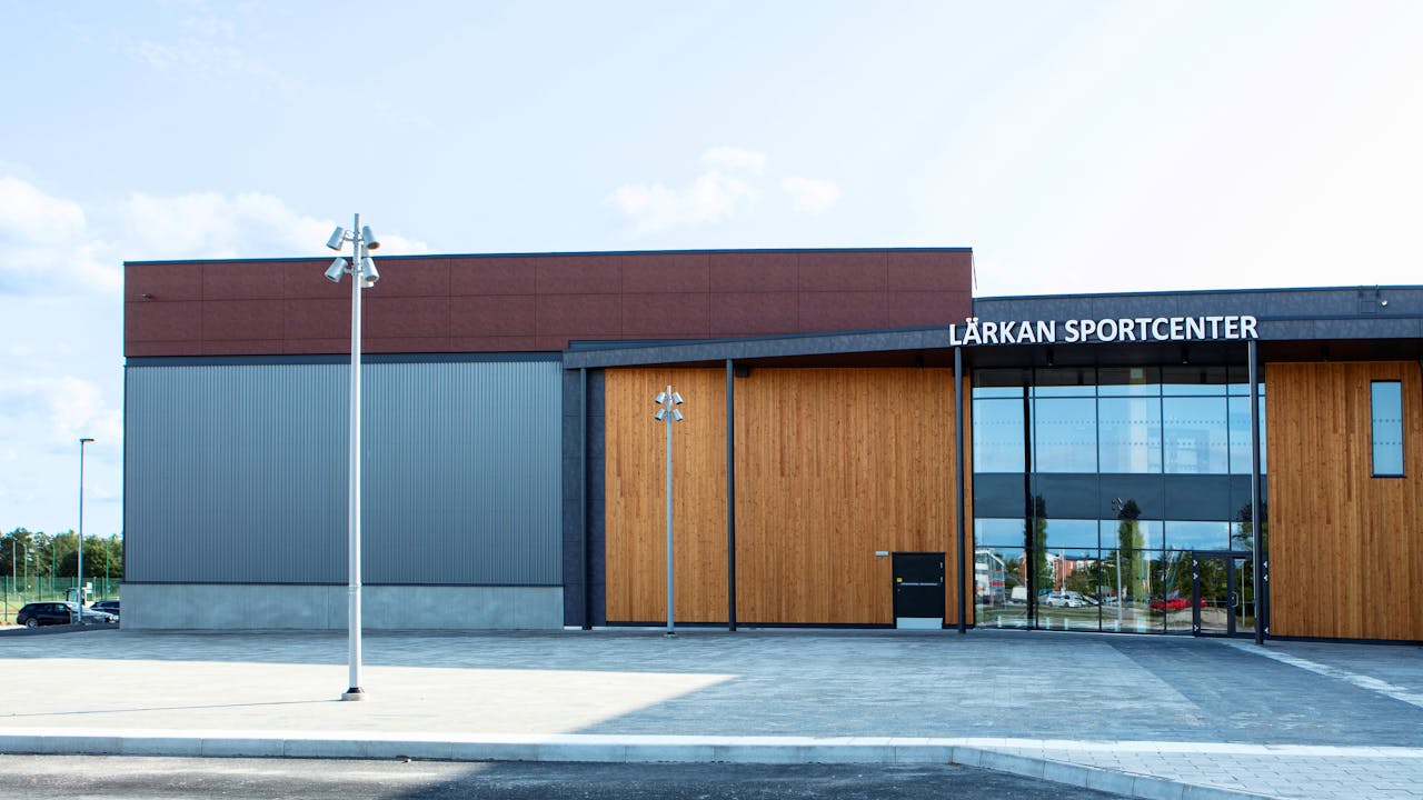 Sports hall 'Lärkan' in Sala, Sweden cladded with Rockpanel Stones Mineral Rust and Basalt Iron facade cladding.