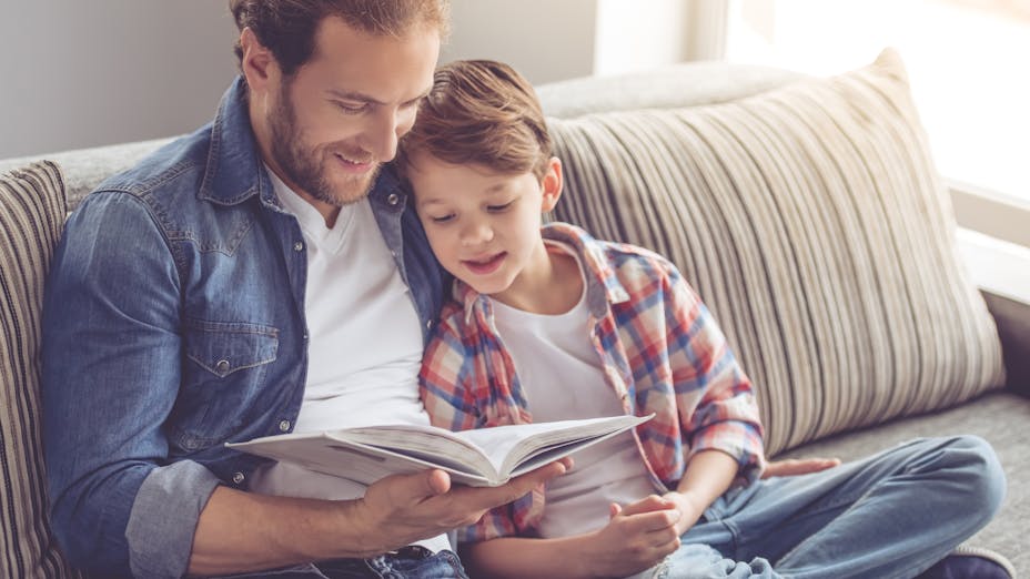 Father reading book for son