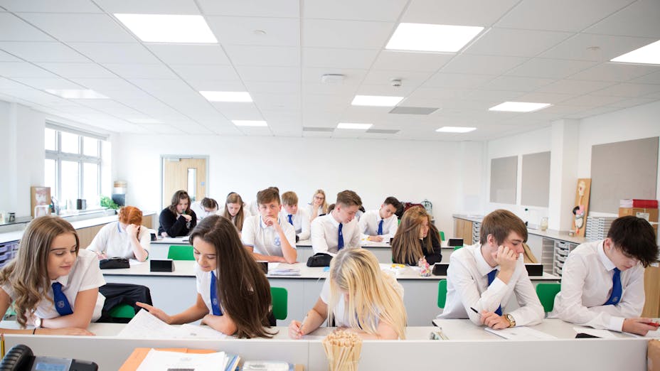 students in the classroom with acoustic ceiling design