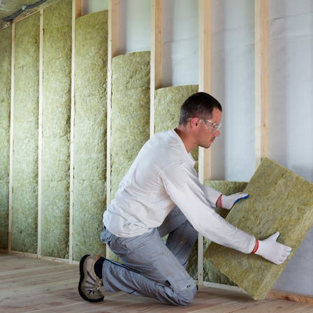 Man installing insulation, Self-builder, Renovation, Timber Frame Wall