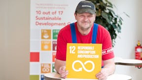 An employee holding Sustainable Development Goal #12: Responsible Consumption and Production for the #iRockGlobalGoals campaign. Keywords: Sustainable Development Goals, SDGs, Global Goals, Sustainability, Employees, Employee, Colleague, Colleagues