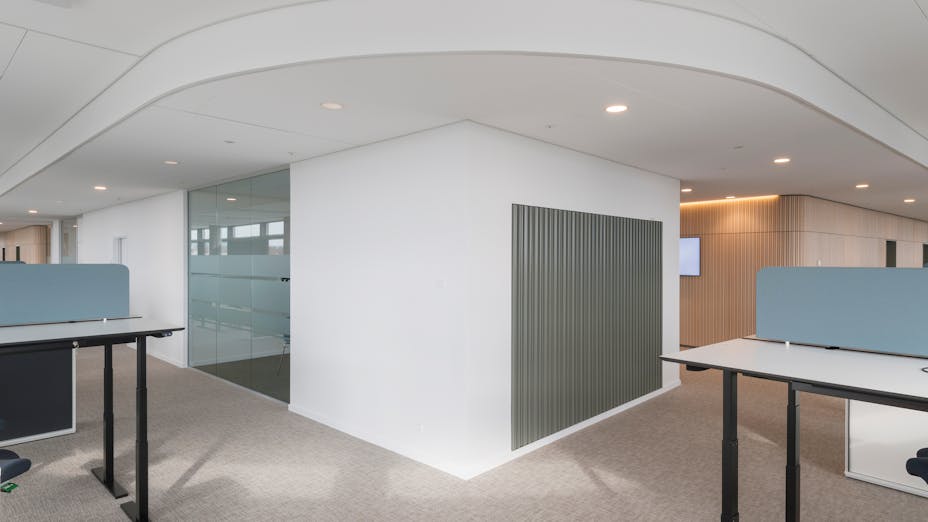 Rockfon ceiling tiles and panels and Chicago Metallic suspension grid installed in open office reception area