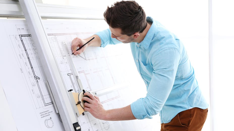 Architect developing the blueprint of a new construction building design for an office building.