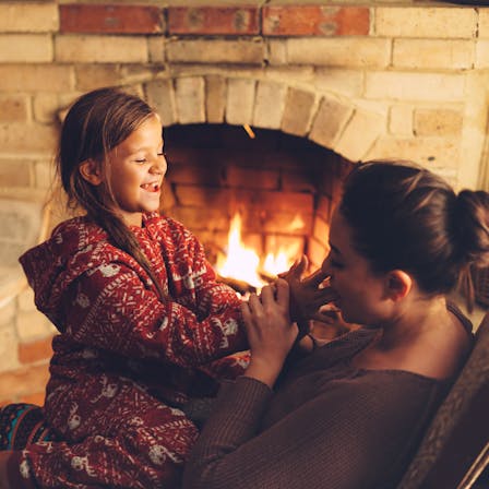 Mother and daughter in front of fireplace