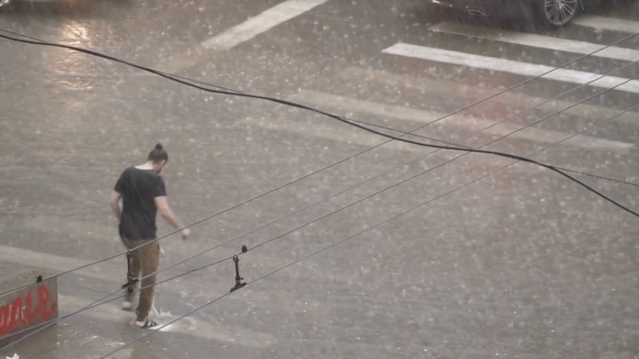 Man walking in heavy rain