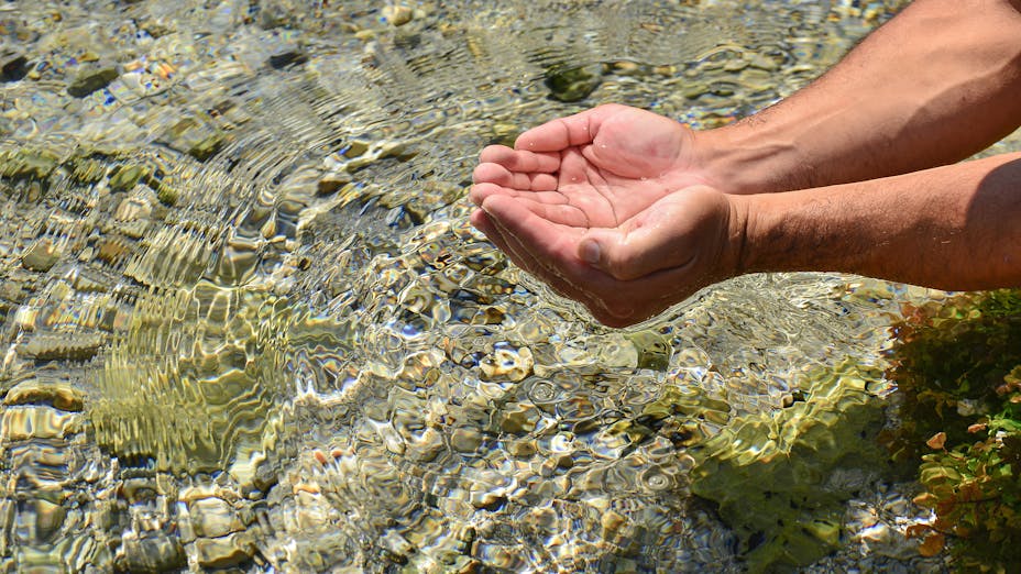 Hands in water source