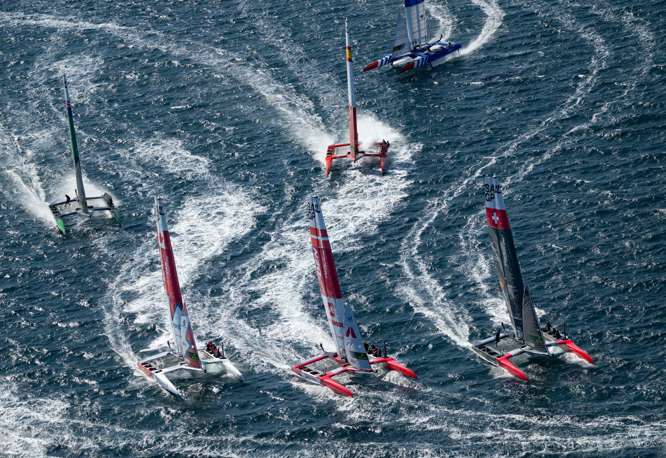 The tightly packed SailGP fleet racing on rough waters in Saint-Tropez.