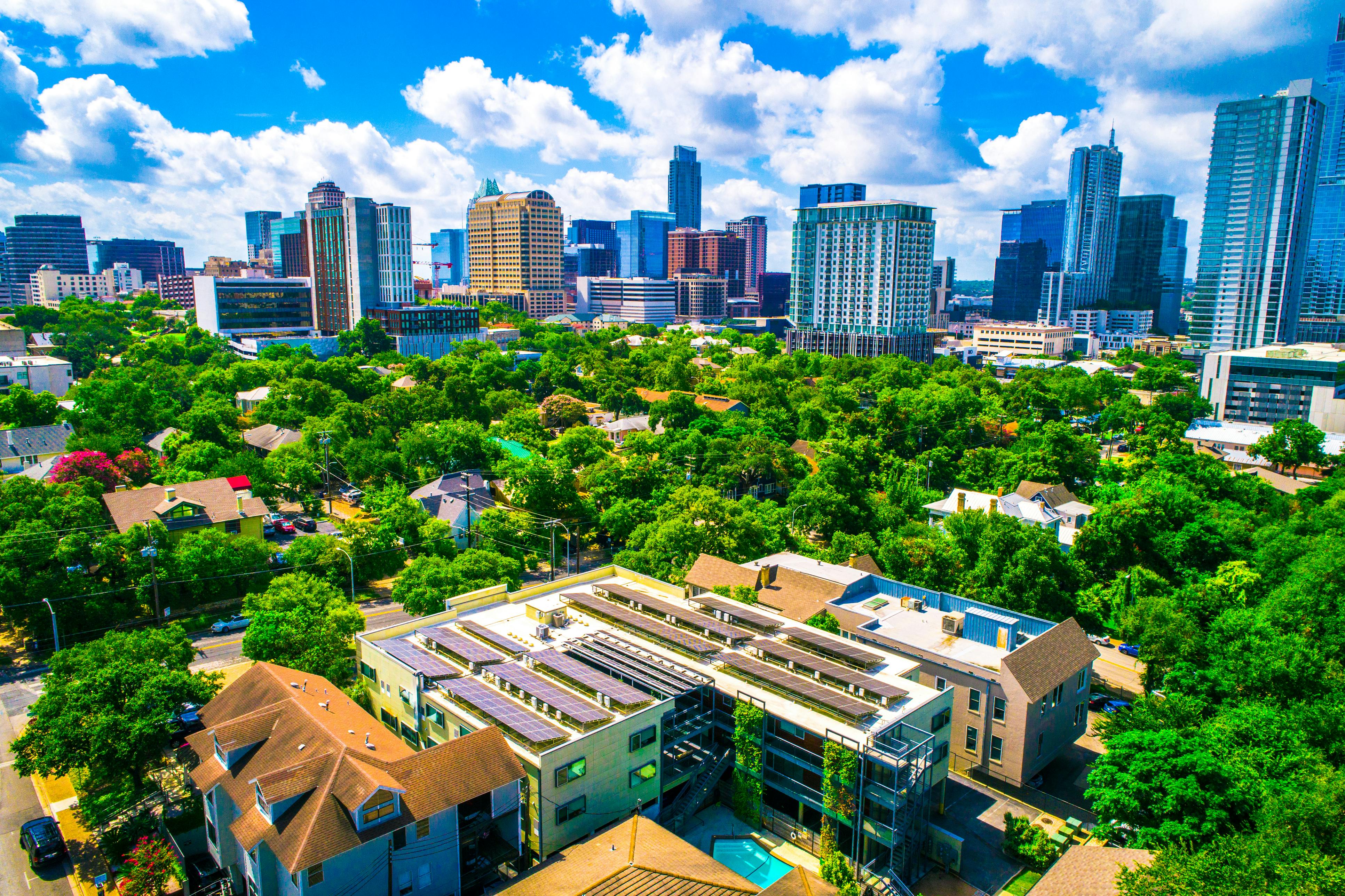 Sustainable urban development practices with homes and buildings integrated into the natural environment. The future of Austin Texas a renewable energy sustainable city.
