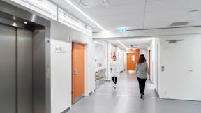 Corridor in Rigshospitalet in Copenhagen Denmark with Rockfon Blanka tiles and Chicago Metallic grid.