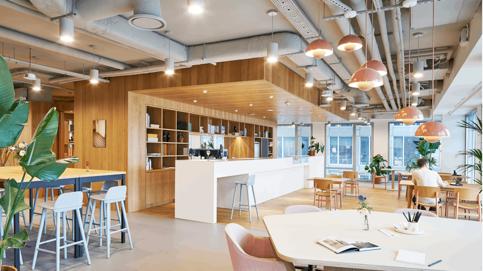 Multi functional space in an open plan office with a seamless acoustic ceiling in concrete grey
