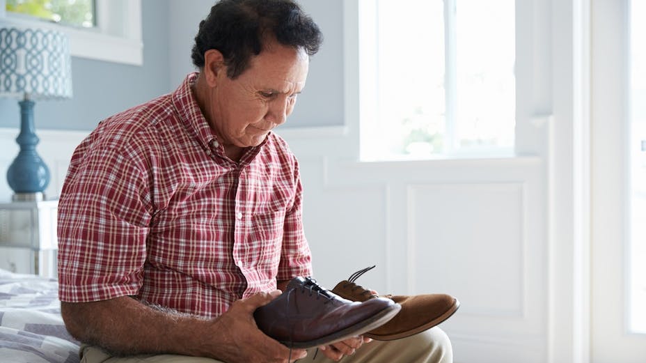 A man with dementia looking at shoes