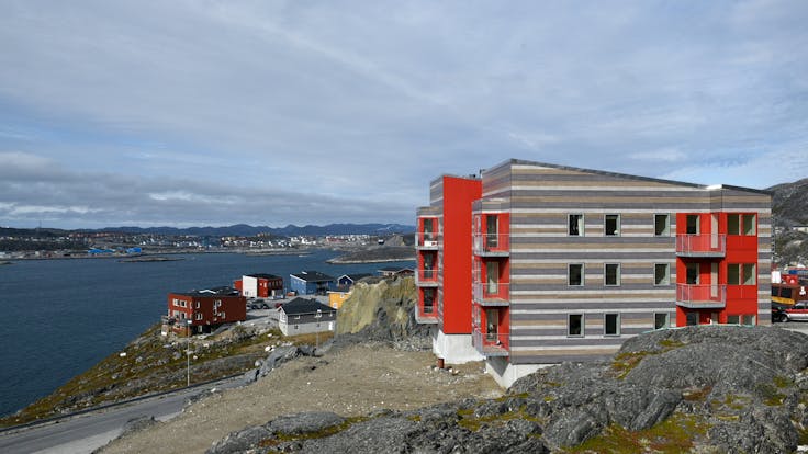 Multi-unit residential in Qinngorput, Nuuk, Greenland cladded with Rockpanel Woods Rhinestone Oak, Carbon Oak, Marble Oak and Rockpanel Colours RAL 095 50 50 in 8 mm Durable.