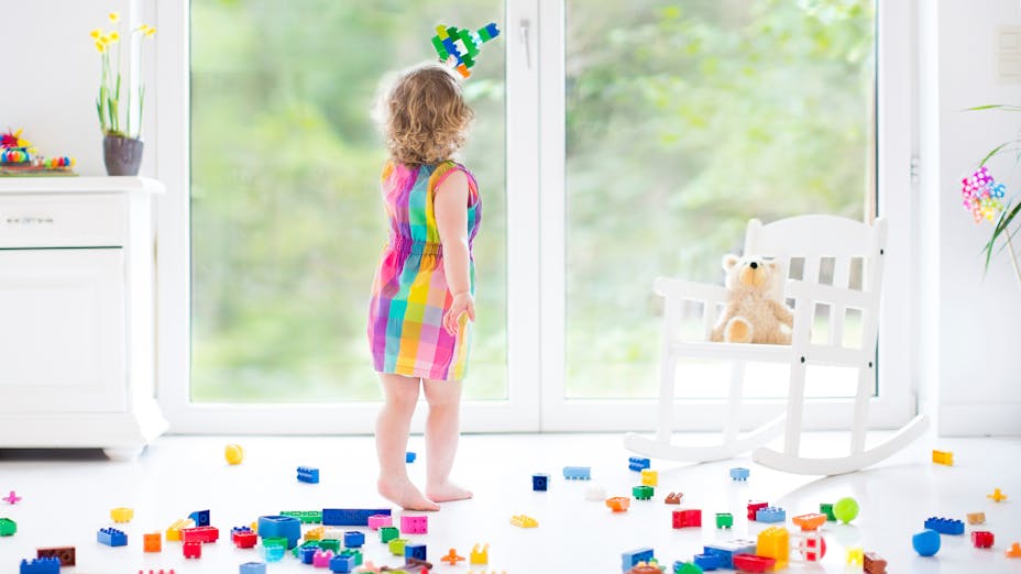 Young girl playing with toy bricks