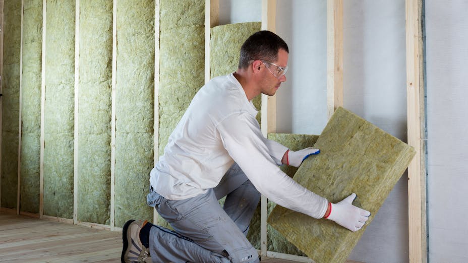 Man installing insulation