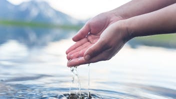 Lake, hands dripping water, refreshing, mountain background