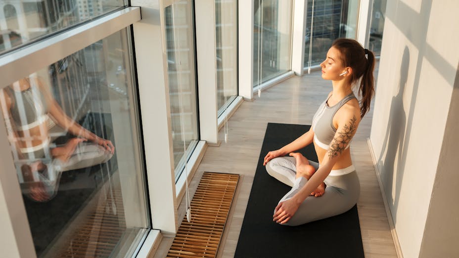 Meditation - young female strectching yoga