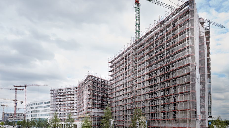 Large buildings being renovated with scaffold and cranes. Intelligent Quarters, Hamburg, Germany