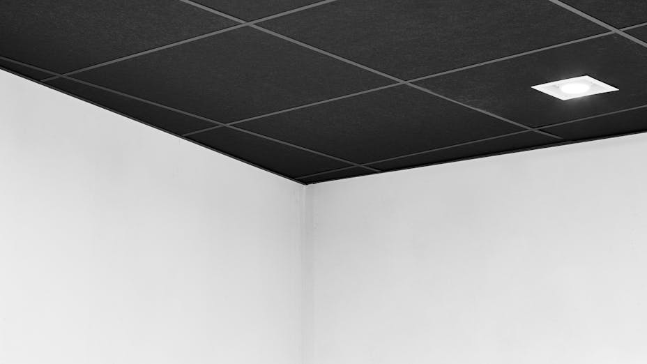 Rockfon Cinema Black ceiling tiles installed with Chicago Metallic 4000 Tempra inside office sound room.