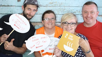 Four employees holding Sustainable Development Goals signs for the #iRockGlobalGoals campaign. Keywords: Sustainable Development Goals, SDGs, Global Goals, Sustainability, Employees, Employee