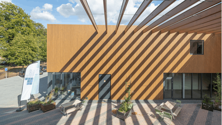 EromesMarko office building and factory in Wijchen, Netherlands cladded with Rockpanel Woods (custom design) facade cladding.