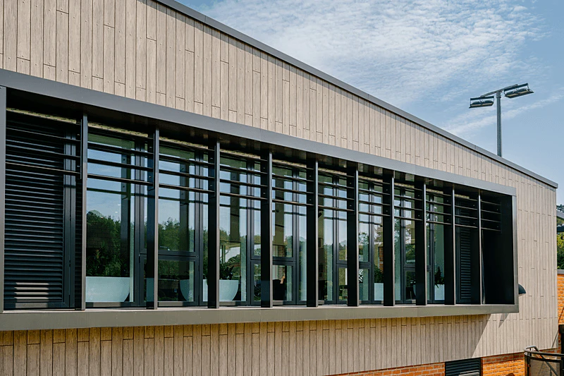 Case Study, Caterham Sports Center, UK, Rockpanel Woods (Rhinestone Oak), Rockpanel Colours (RAL 7030).