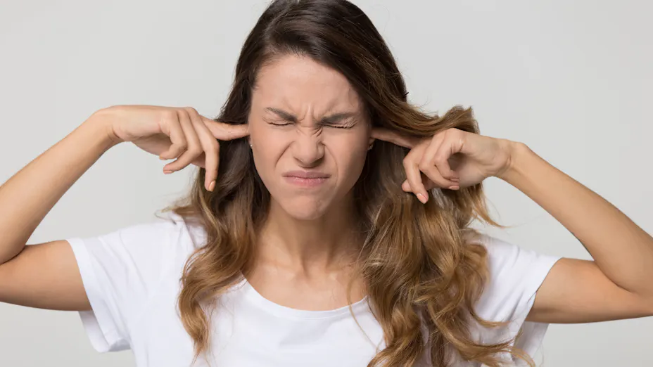 woman covering ears to protect from noise