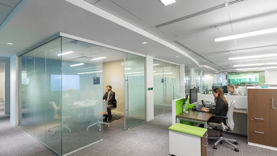 Rockfon Plenum Barrier Board installed between open office and meeting room.