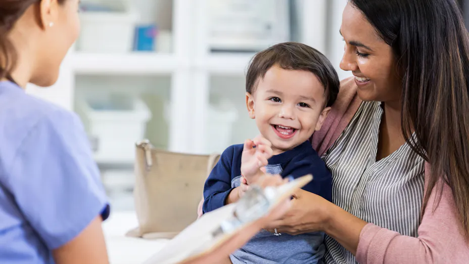 Smiling child and mother at medical office