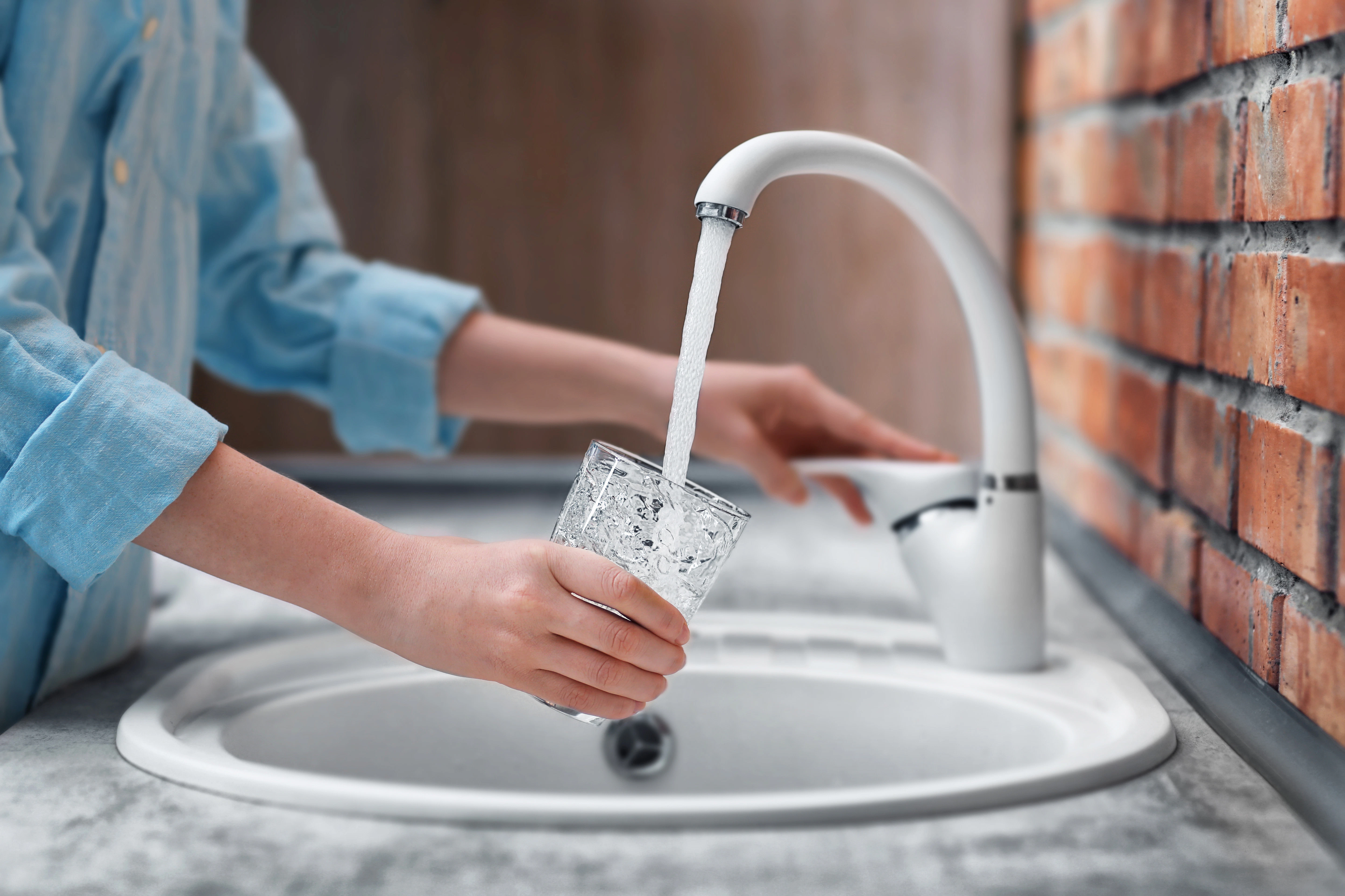 glass of water, female hands pouring water in glass cup, tap water, austria